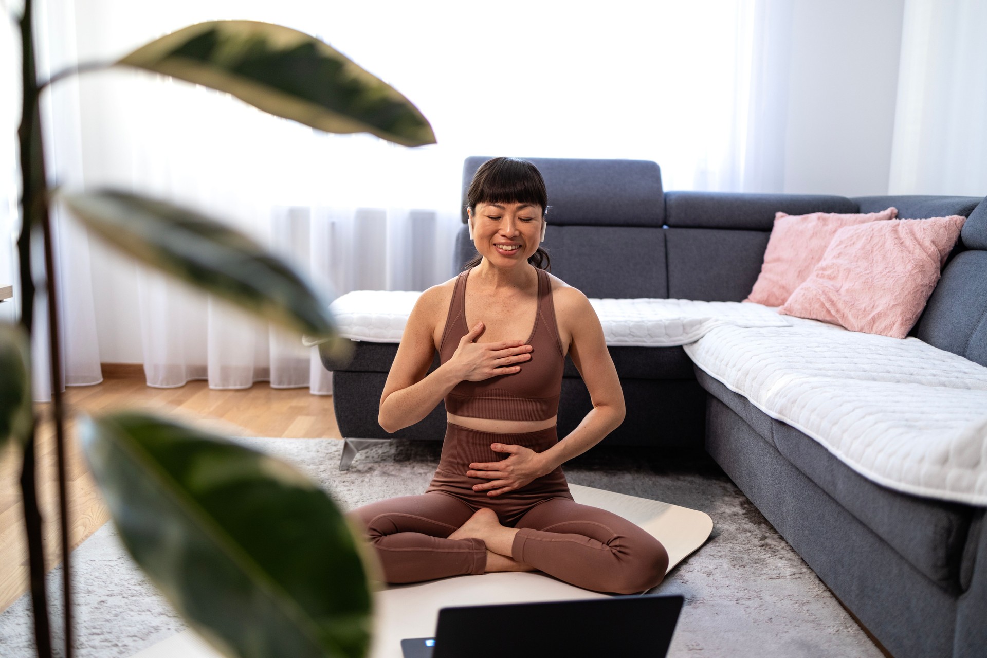 Yoga instructor greeting online clients before exercising.